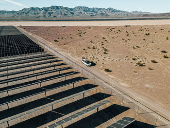 Off grid self contained campervan van life recreational vehicle parked next to a massive solar farm