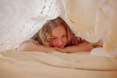 Portrait of girl lying on bed