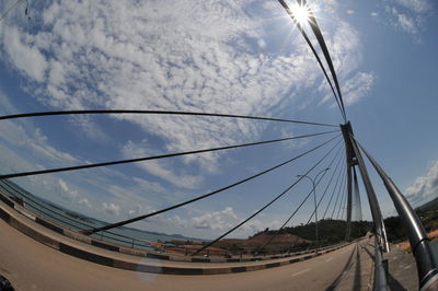 Low angle view of vehicles on road against sky