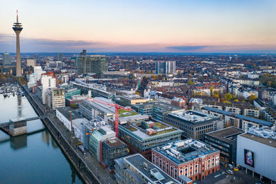 High angle view of buildings in city at sunset