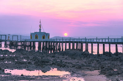 Scenic view of beach by sea against sky during sunset