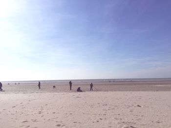 People on beach against sky