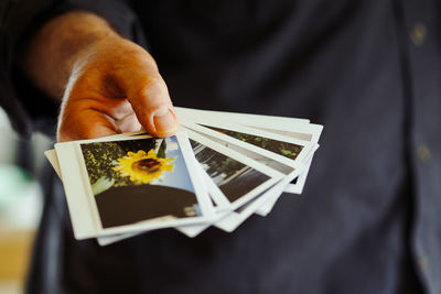 Midsection of man holding instant print transfers