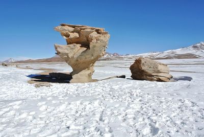 Scenic view of snowcapped mountain against clear blue sky