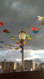 Low angle view of flags hanging against buildings in city