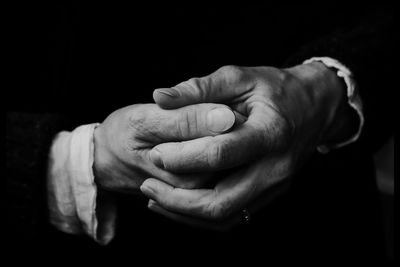 Close-up of hands over black background