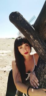 Portrait of beautiful woman sitting on land