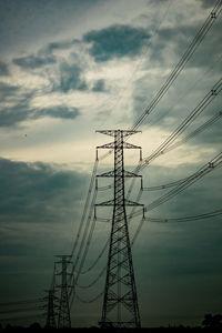 Low angle view of electricity pylon against sky