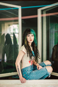 Portrait of young woman sitting outdoors