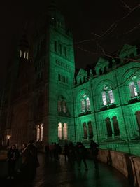 People in illuminated building at night