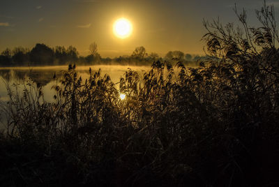 Scenic view of lake against sky during sunset