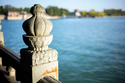 Close-up of cross by lake