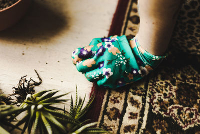 Close-up of baby hand on table at home