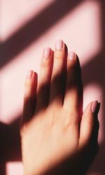 Cropped hand of woman touching wall at home