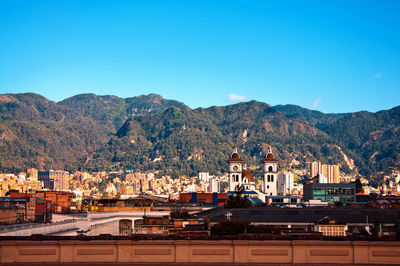 Cityscape and andes against blue sky