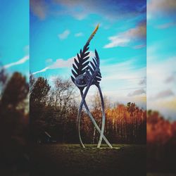 Digital composite image of sculpture against trees