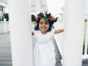 Portrait of happy girl standing against white background