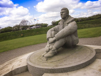 Statue in park against sky