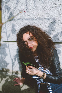 Portrait of young woman holding umbrella