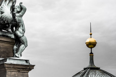 Low angle view of statue of building against sky