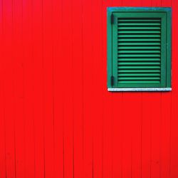 Full frame shot of window on red wall