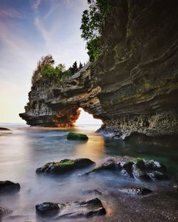 Scenic view of rocks in sea against sky