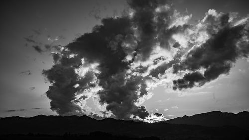 Low angle view of silhouette mountain against dramatic sky