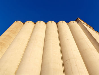 Low angle view of building against clear blue sky