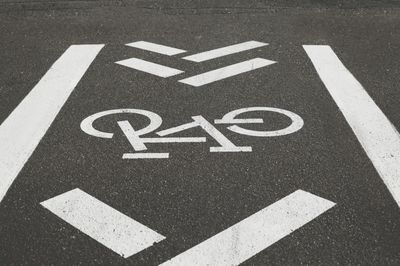 High angle view of arrow sign on road in city