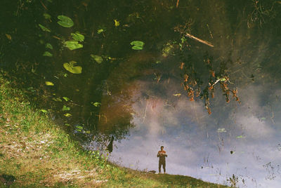 Rear view of man walking on field