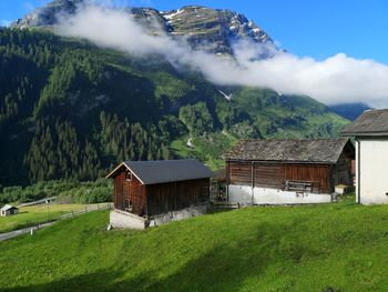 Scenic view of landscape and houses against mountain