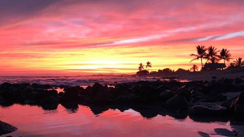 Scenic view of sea against romantic sky at sunset