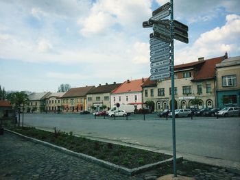 Buildings against cloudy sky