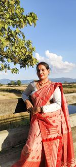 Portrait of young woman sitting on beach