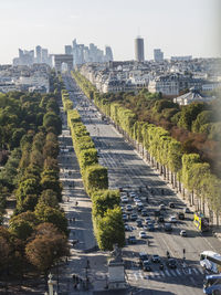 Vehicles on champs-elysees toward arc de triomphe in city
