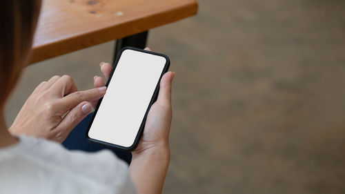 Midsection of man using mobile phone