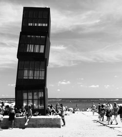 People at beach against sky