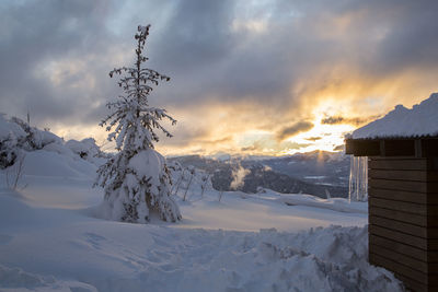 Snow covered mountains against sky during sunset