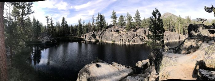 Panoramic view of lake in forest against sky