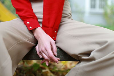 Midsection of woman sitting on bench