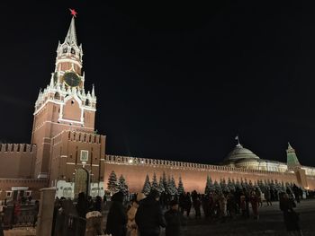 Crowd outside historic building against sky at night