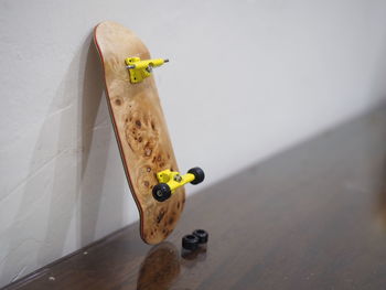 Close-up shot of finger skateboard placed on a white wall