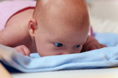 Close-up of baby boy sleeping on bed at home