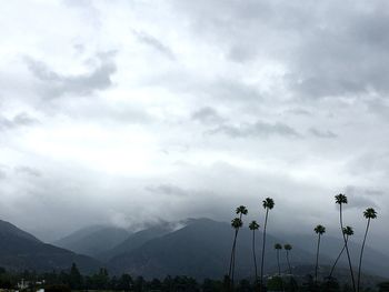 Scenic view of mountains against cloudy sky
