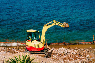Deck chairs on rocks by sea