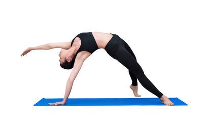 Midsection of woman with arms raised against white background