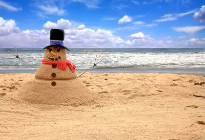 Rear view of man on beach against sky