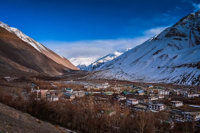 The picturesque sight of mountains capped with snow against the sky. 