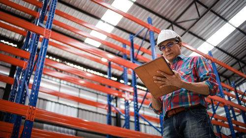 Low angle view of man working in factory