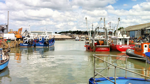 Boats moored at harbor